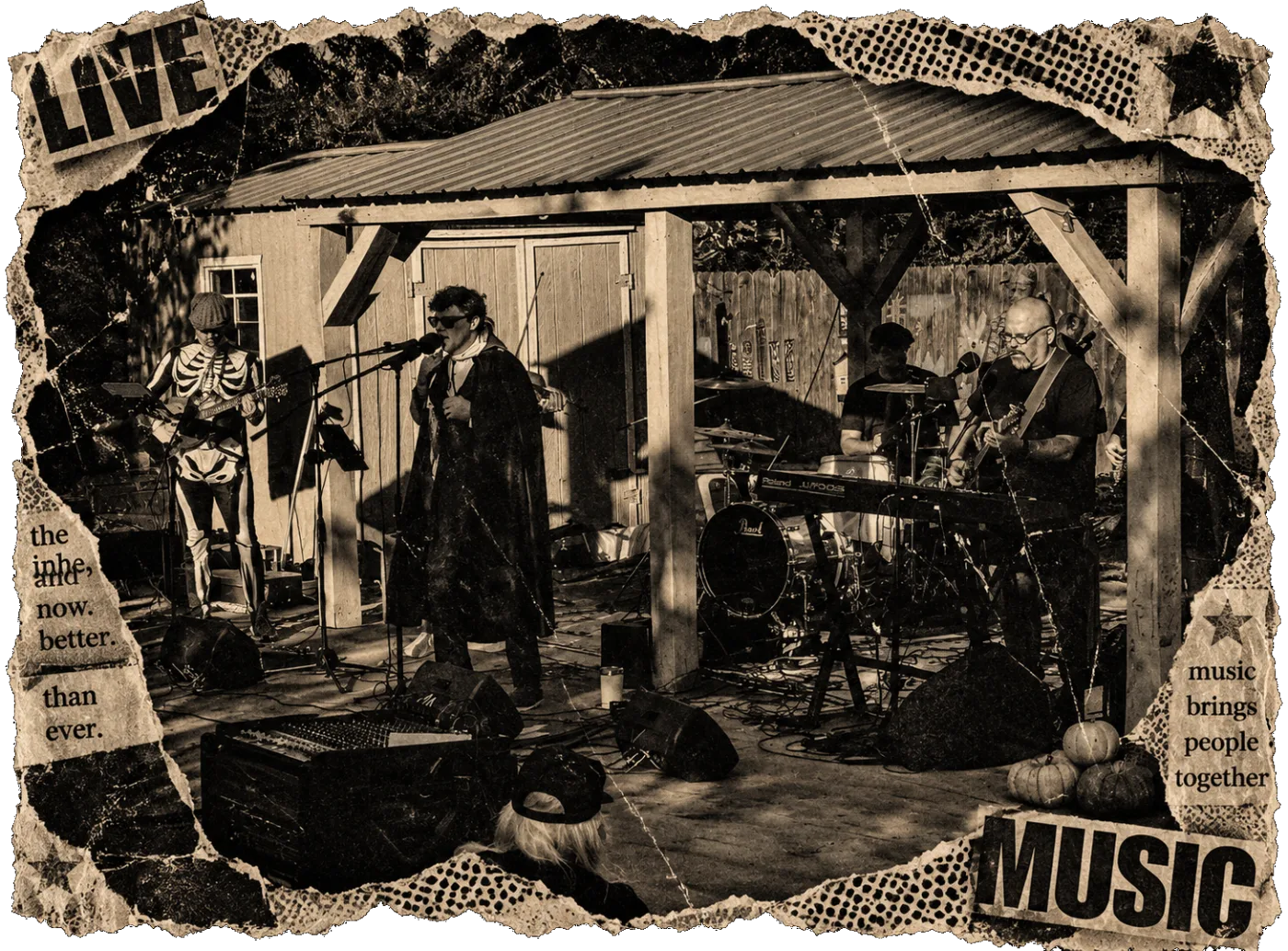 The whole band under the pavilion at Dowdell&rsquo;s Pre-Halloween Bash, the guitarist in a skeleton suit and the singer in a cape